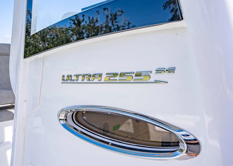 Slide: The Image of 2025 Sea Hunt Ultra 255 SE boat emblem with chrome detail. - 13