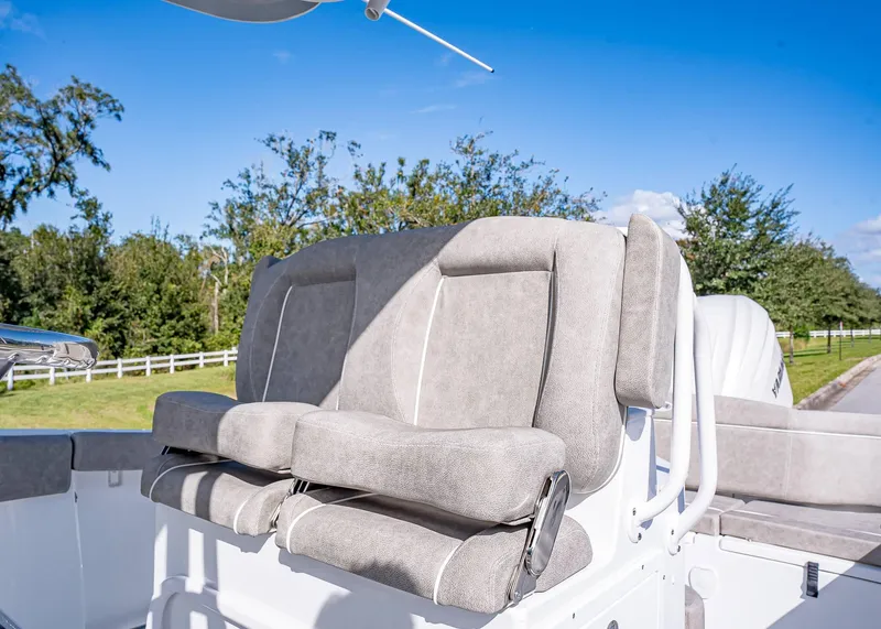 Slide: The Image of 2025 Sea Hunt Ultra 255 SE boat seats, gray upholstery, outdoor setting. - 14