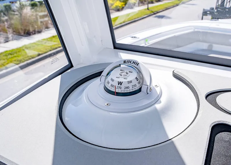 Slide: The Image of Compass on 2025 Sea Hunt Ultra 255 SE boat dashboard, sunny day. - 15