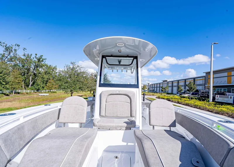 Slide: The Image of 2025 Sea Hunt Ultra 255 SE boat interior with seating, outdoors under blue sky. - 19