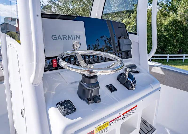 Slide: The Image of 2025 Sea Hunt Ultra 255 SE boat dashboard with Garmin navigation system. - 23