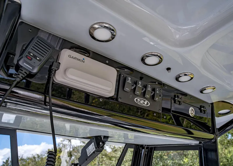 Slide: The Image of 2025 Sea Hunt Ultra 255 SE boat dashboard with Garmin equipment and control panel. - 10