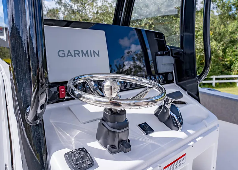 Slide: The Image of 2025 Sea Hunt Ultra 255 SE boat dashboard with Garmin navigation system. - 11