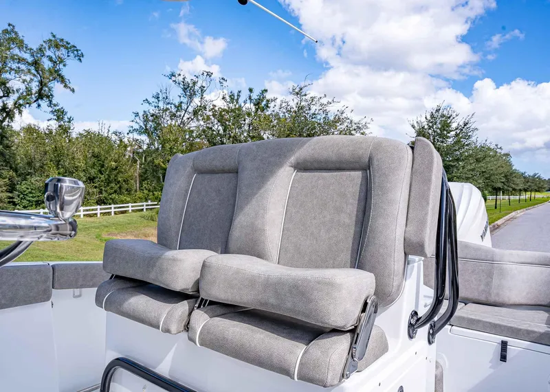 Slide: The Image of 2025 Sea Hunt Ultra 255 SE boat seats with scenic outdoor background. - 12