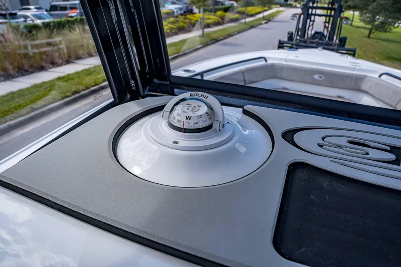 Slide: The Image of 2025 Sea Hunt Ultra 255 SE boat with Ritchie compass on deck. - 13