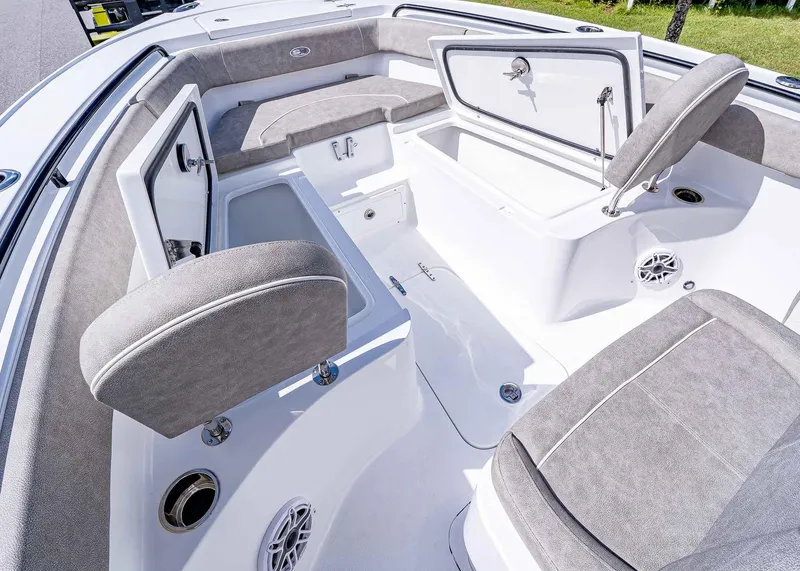 Slide: The Image of 2025 Sea Hunt Ultra 255 SE boat interior with open storage compartments and cushioned seating. - 21