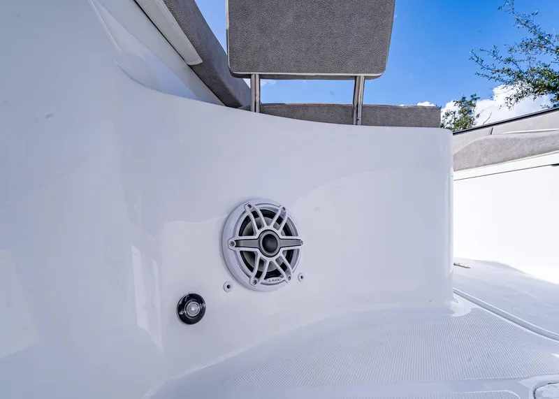 Slide: The Image of 2025 Sea Hunt Ultra 255 SE boat speaker and seating detail against blue sky. - 22
