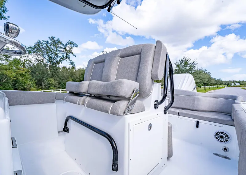 Slide: The Image of 2025 Sea Hunt Ultra 255 SE boat interior with cushioned seating and sleek design. - 23