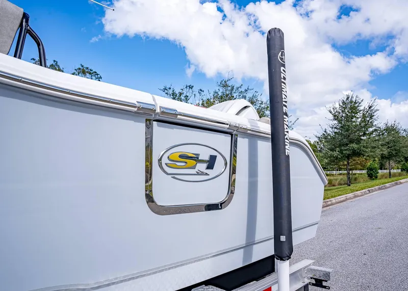 Slide: The Image of 2025 Sea Hunt Ultra 255 SE boat side view with logo and clear sky. - 3