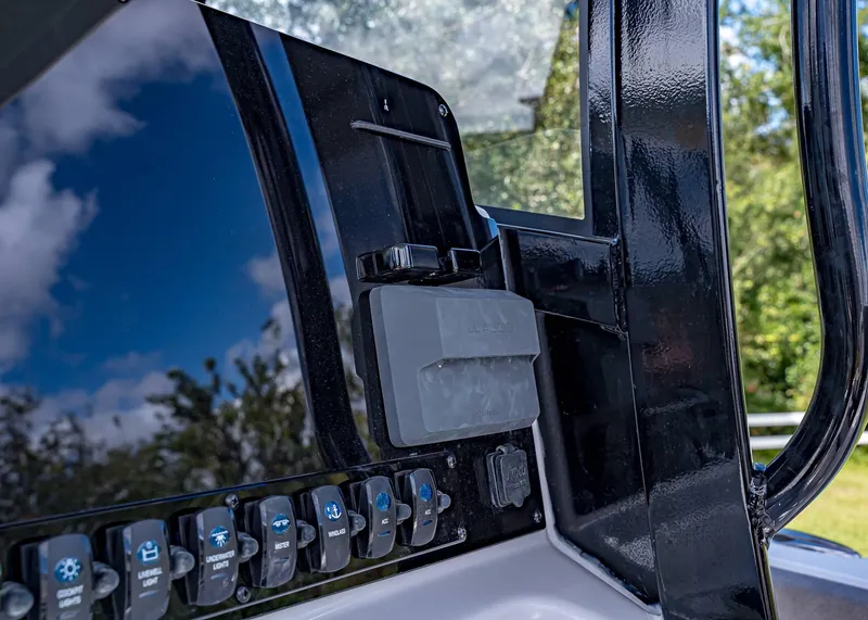 Slide: The Image of 2025 Sea Hunt Ultra 255 SE dashboard with control switches and sleek design. - 9