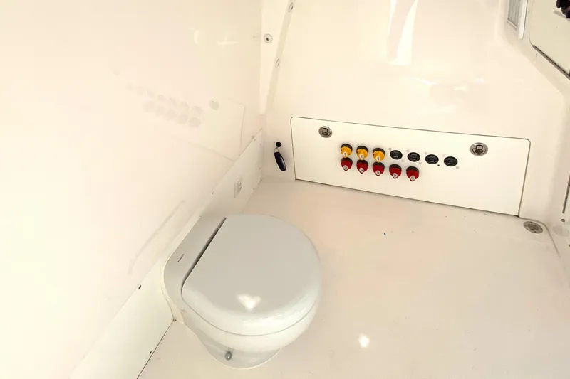 Slide: The Image of 2023 Invincible 46 Catamaran interior with toilet and control panel. - 10