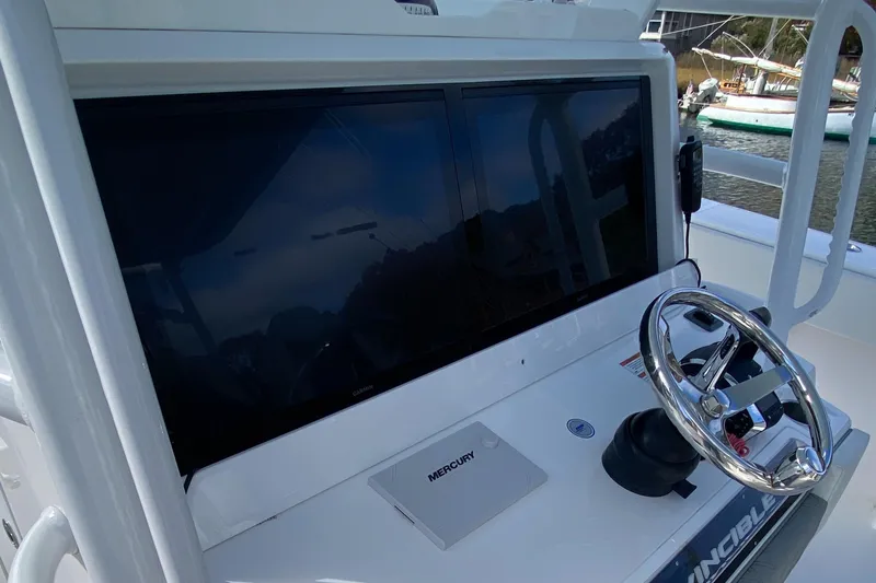 Slide: The Image of 2023 Invincible 46 Catamaran helm with steering wheel and electronic display. - 12