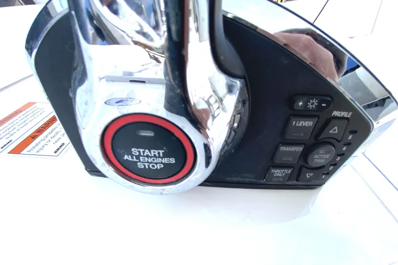 Slide: The Image of Control panel of 2023 Invincible 46 Catamaran Plus, featuring engine start-stop button. - 14