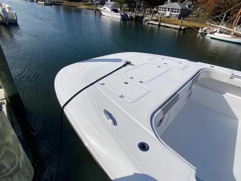 Slide: The Image of 2023 Invincible 46 Catamaran docked, showcasing sleek design and spacious deck. - 2