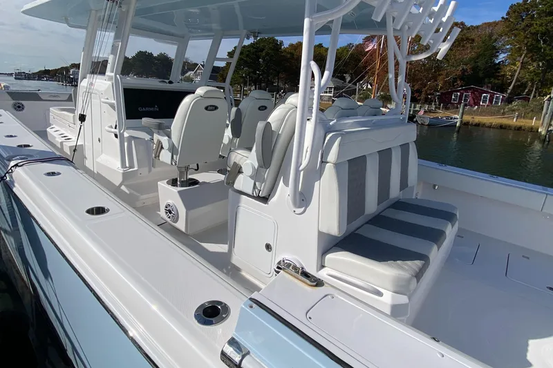 Slide: The Image of 2023 Invincible 46 Catamaran Plus Quad Axle Trailer, luxury seating, docked by waterfront. - 22