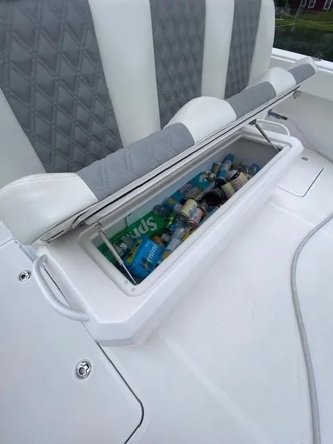 Slide: The Image of 2023 Invincible 46 Catamaran Plus, open storage with drinks, gray and white seating. - 23