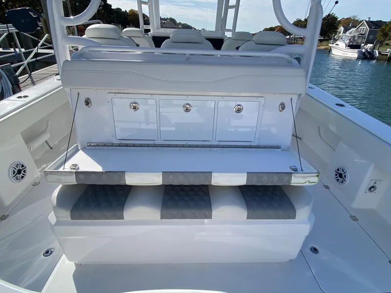 Slide: The Image of 2023 Invincible 46 Catamaran Plus Quad Axle Trailer, featuring spacious seating and storage compartments. - 24