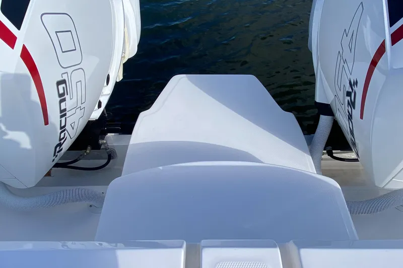 Slide: The Image of 2023 Invincible 46 Catamaran Plus with dual outboard engines on water. - 28