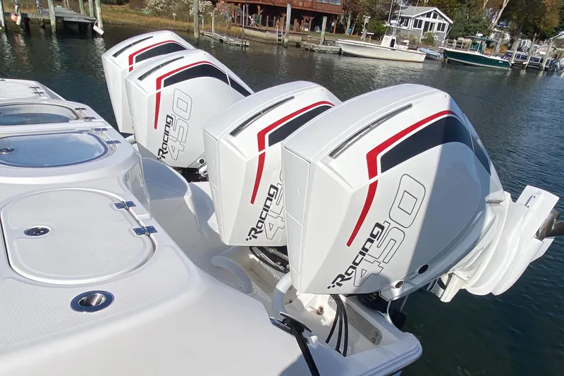 Slide: The Image of 2023 Invincible 46 Catamaran with powerful quad outboard engines on water. - 29