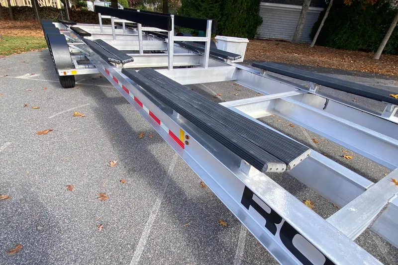 Slide: The Image of 2023 Invincible 46 Catamaran Plus Quad Axle Trailer, sturdy design, parked outdoors. - 33