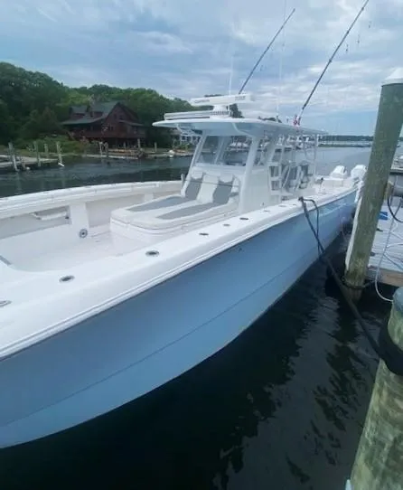 Slide: The Image of 2023 Invincible 46 Catamaran docked, showcasing sleek design and spacious deck. - 4