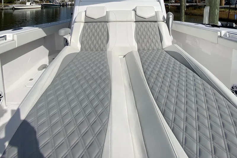 Slide: The Image of Luxurious seating on 2023 Invincible 46 Catamaran, featuring diamond-stitched upholstery. - 6