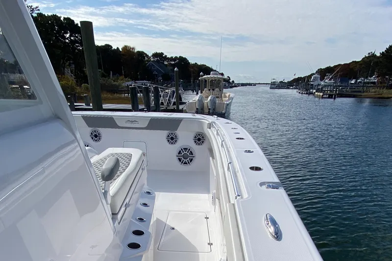 Slide: The Image of 2023 Invincible 46 Catamaran Plus Quad Axle Trailer docked in a scenic marina. - 8