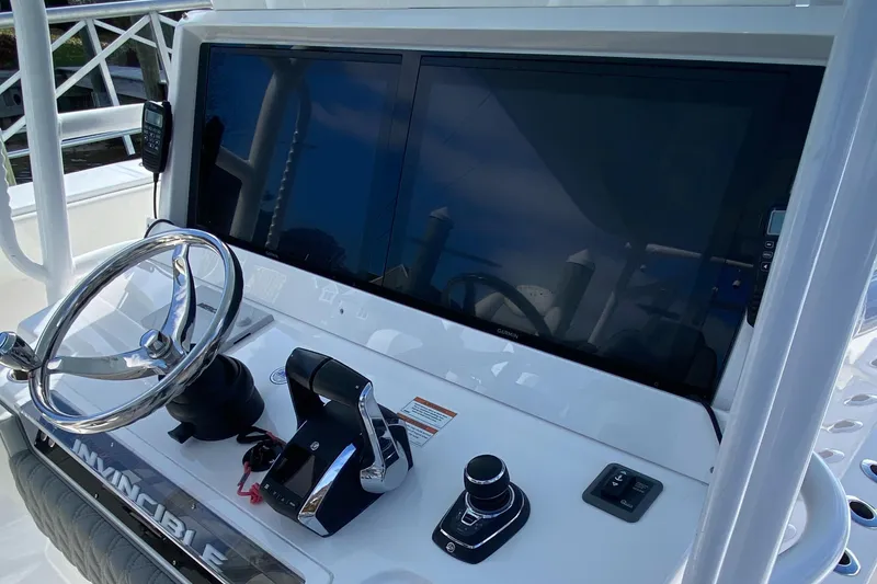Slide: The Image of 2023 Invincible 46 Catamaran helm with dual screens and controls. - 13