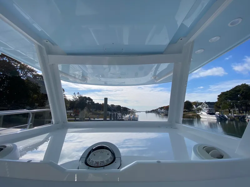 Slide: The Image of 2023 Invincible 46 Catamaran Plus Quad Axle Trailer, view from helm, docked in marina. - 16