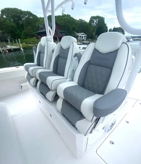 Slide: The Image of 2023 Invincible 46 Catamaran Plus Quad Axle Trailer, luxurious seating, waterfront view. - 17