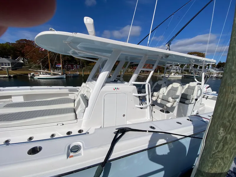 Slide: The Image of 2023 Invincible 46 Catamaran Plus Quad Axle Trailer docked, showcasing sleek design and spacious seating. - 9