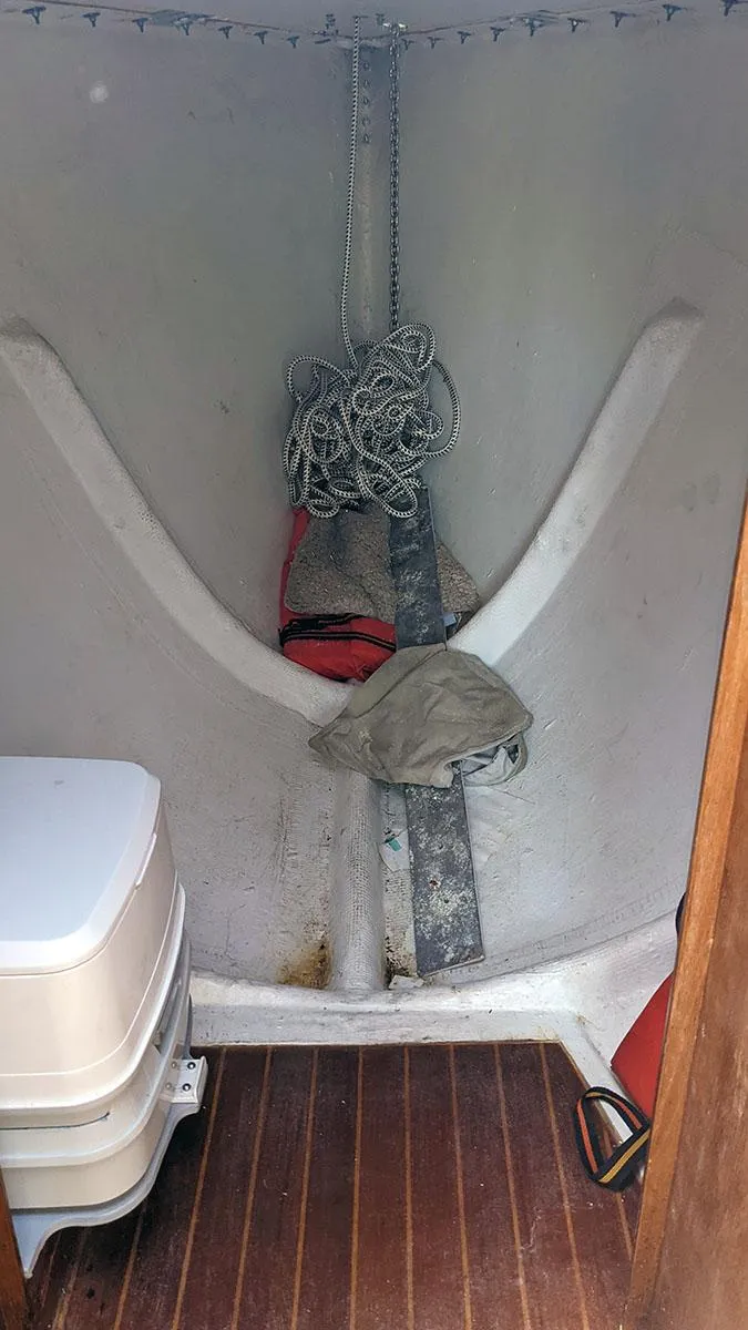 Slide: The Image of Interior of 1985 Soverel 33 sailboat with anchor chain and portable toilet. - 16