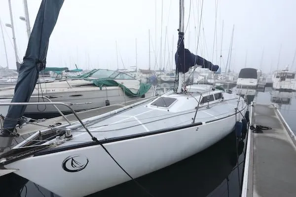 Slide: The Image of 1985 Soverel 33 sailboat docked in a foggy marina. - 21