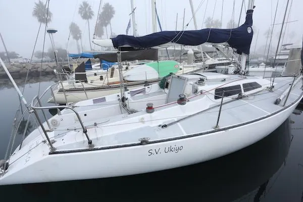 Slide: The Image of 1985 Soverel 33 sailboat "S.V. Ukiyo" docked in a foggy marina. - 23