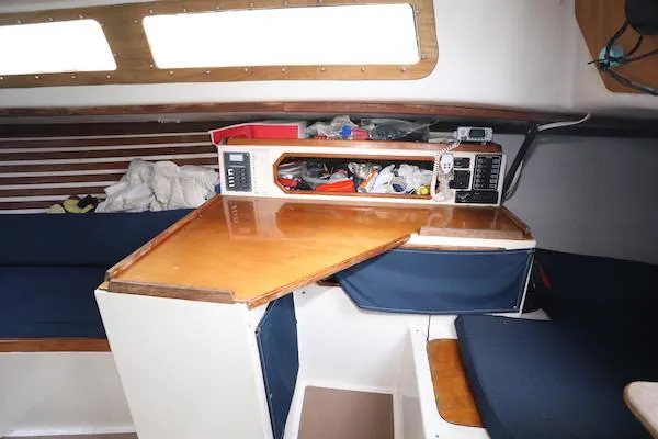 Slide: The Image of Interior of 1985 Soverel 33 sailboat with wooden table and storage compartments. - 4