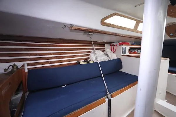 Slide: The Image of Interior of a 1985 Soverel 33 sailboat with blue seating and wooden accents. - 7