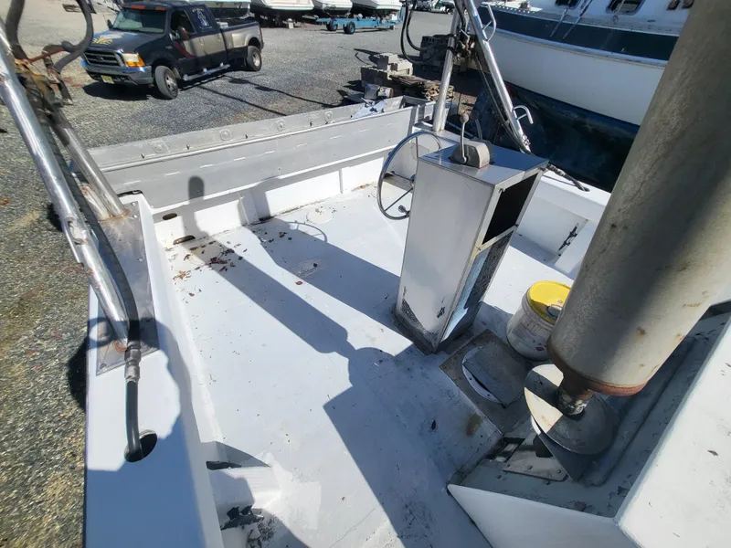 Slide: The Image of 1985 Kinnamon Pilot House Chesapeake Deadrise boat deck with steering wheel and equipment. - 14