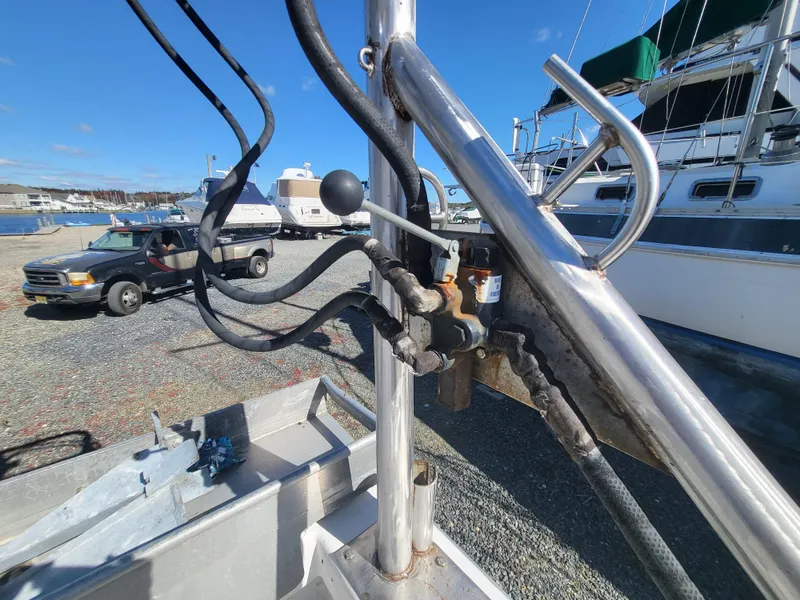 Slide: The Image of Close-up of 1985 Kinnamon Pilot House Chesapeake Deadrise boat controls in a marina setting. - 15