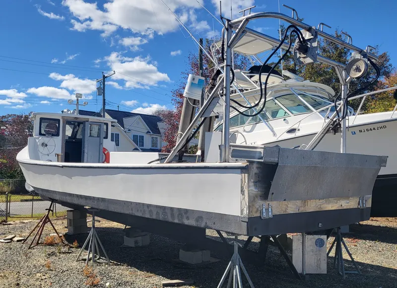 Slide: The Image of 1985 Kinnamon Pilot House Chesapeake Deadrise boat on stands, clear sky background. - 29