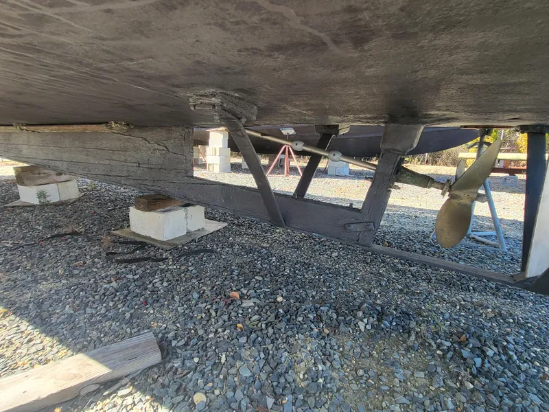 Slide: The Image of Underside of 1985 Kinnamon Pilot House Chesapeake Deadrise boat on gravel. - 30