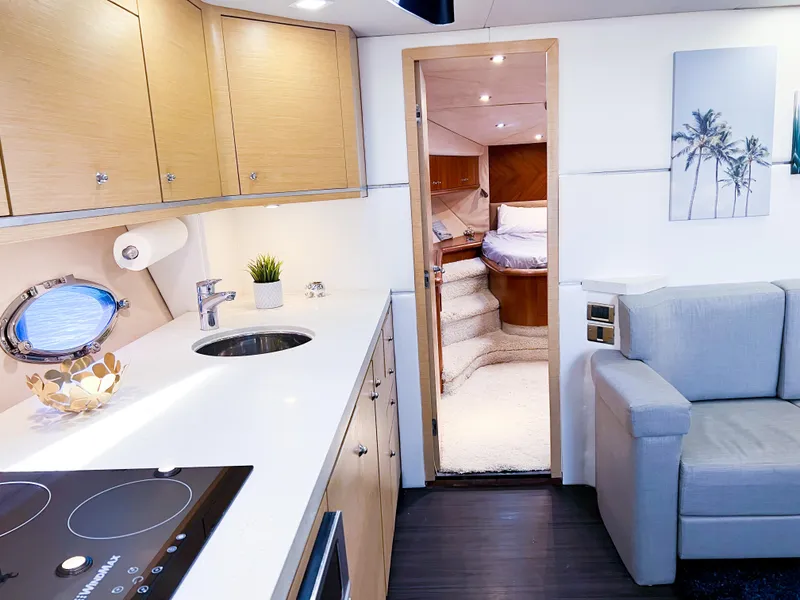 Slide: The Image of Interior of 2005 Sunseeker Predator 68 yacht, featuring modern kitchen and cozy living area. - 15