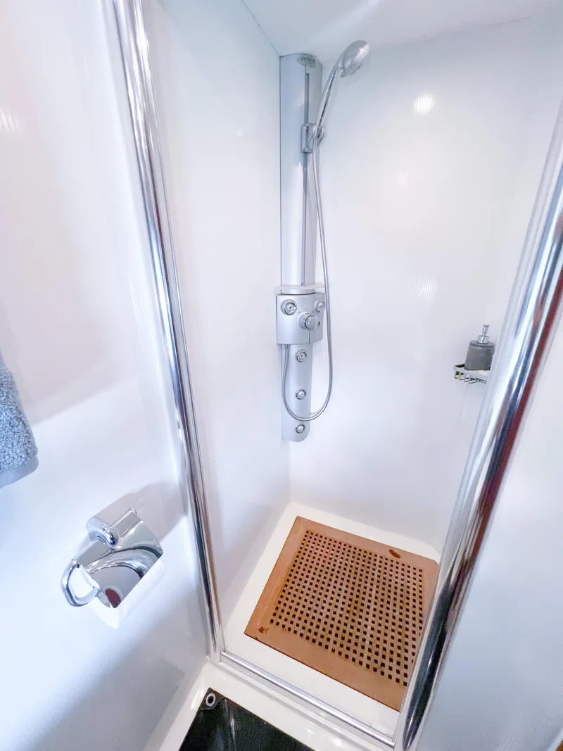 Slide: The Image of Shower area in 2005 Sunseeker Predator 68 yacht with modern fixtures and wooden floor mat. - 19