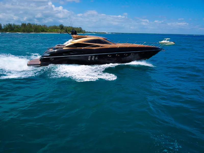 Slide: The Image of 2005 Sunseeker Predator 68 yacht cruising on blue ocean waters. - 2