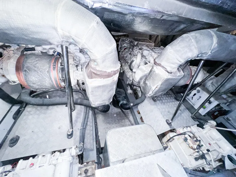 Slide: The Image of Engine room of 2005 Sunseeker Predator 68 yacht, showcasing dual engines and exhaust systems. - 23