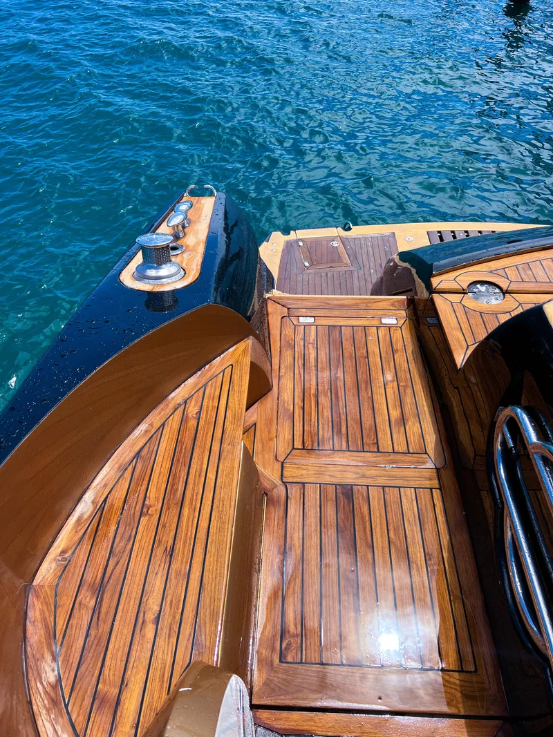 Slide: The Image of 2005 Sunseeker Predator 68 yacht with polished wooden deck by the water. - 34