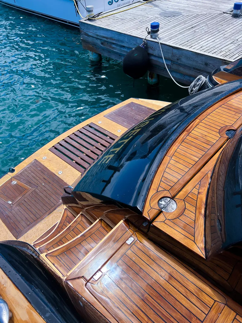 Slide: The Image of Sunseeker Predator 68 yacht, 2005 model, with sleek wooden deck by the dock. - 35