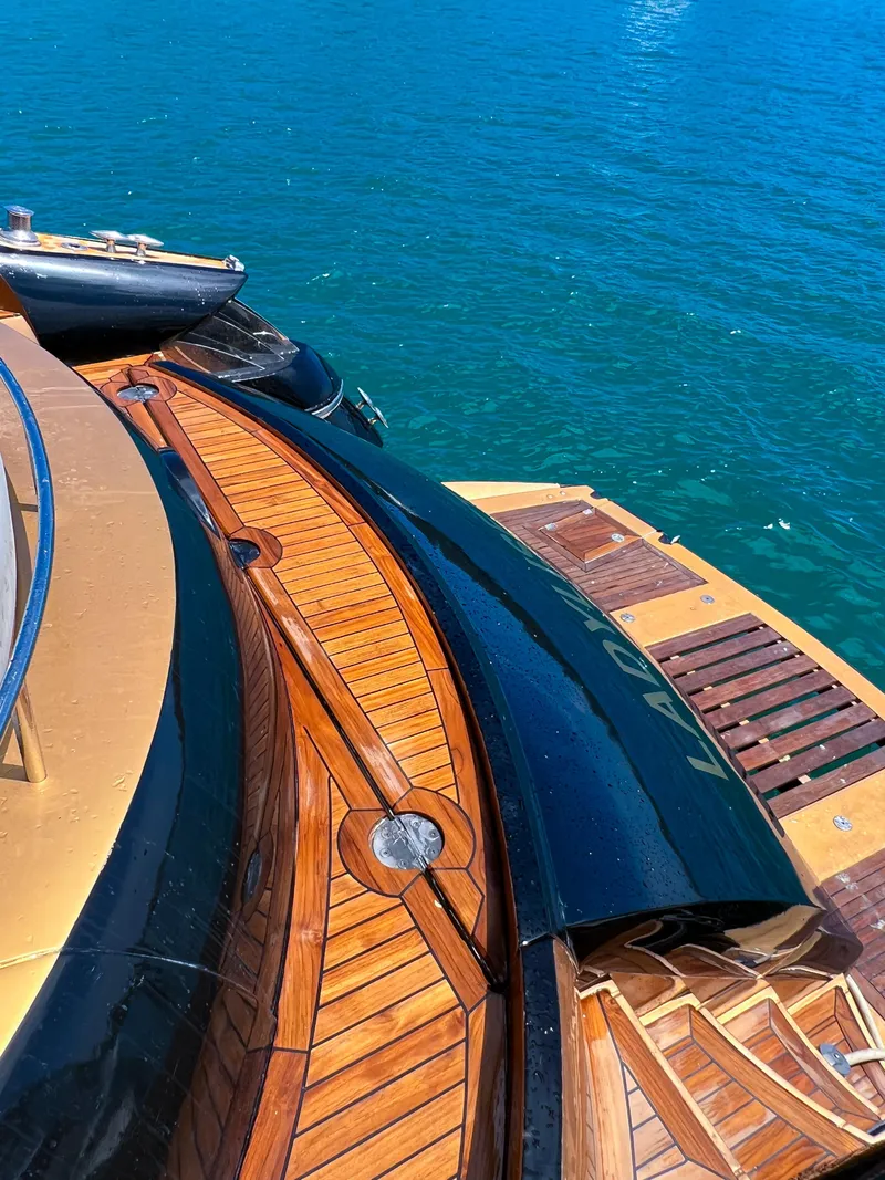 Slide: The Image of Sunseeker Predator 68 yacht, 2005 model, with sleek wooden deck on blue water. - 37