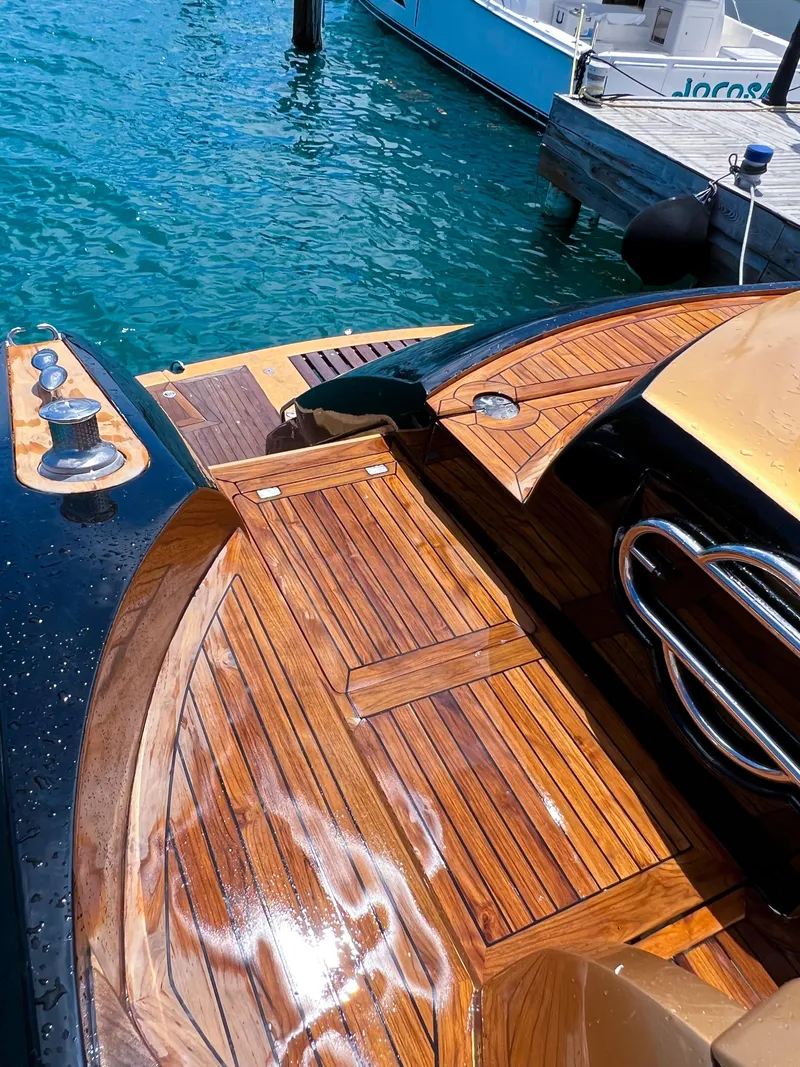 Slide: The Image of Sunseeker Predator 68 (2005) yacht with polished wooden deck by the water. - 38