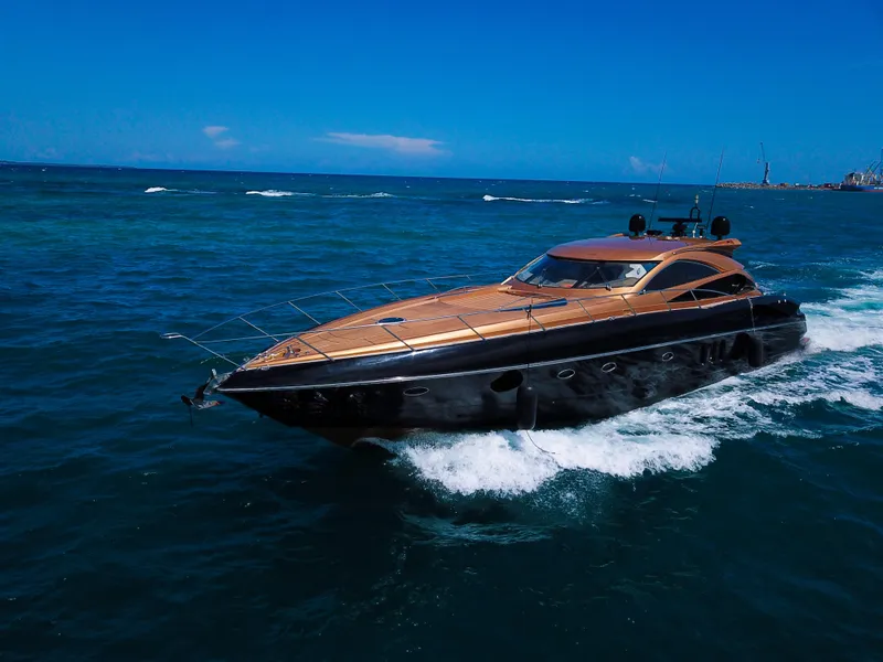 Slide: The Image of 2005 Sunseeker Predator 68 yacht cruising on open sea under clear blue sky. - 41