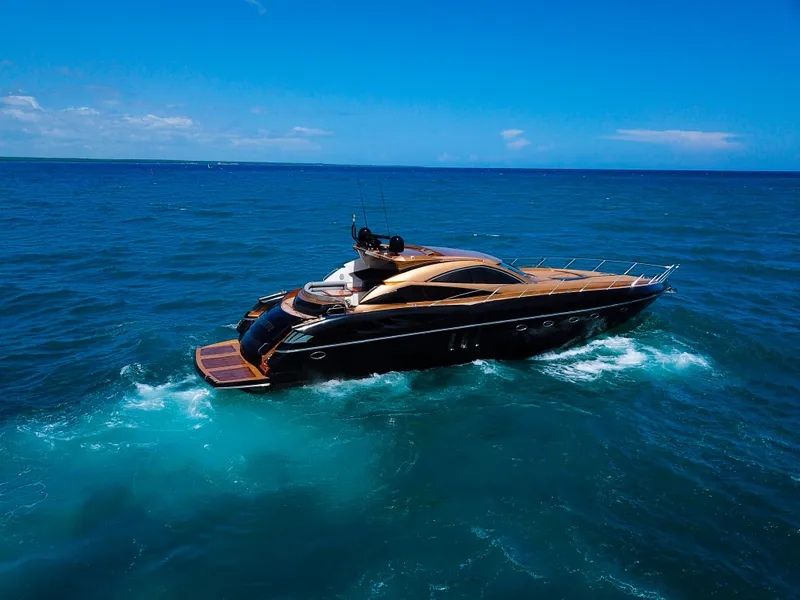 Slide: The Image of 2005 Sunseeker Predator 68 yacht cruising on open sea under clear blue sky. - 43